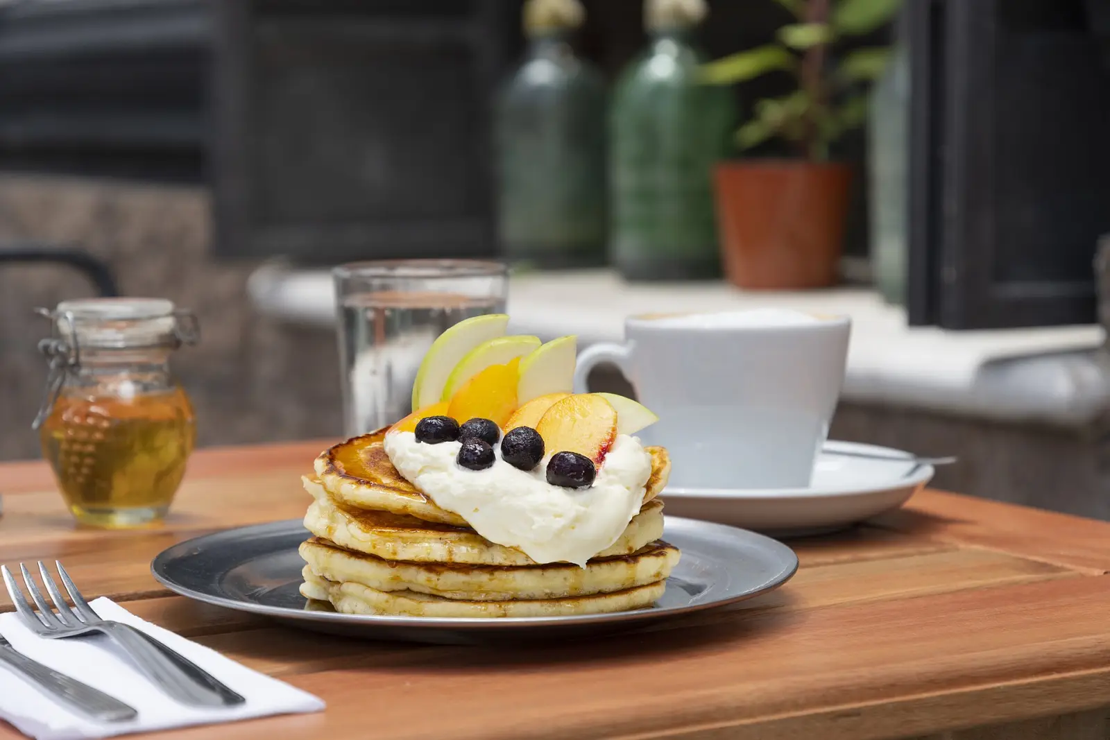 Pancakes and coffee on a cafe table. The photo was not taken at a Gainesville restaurant.