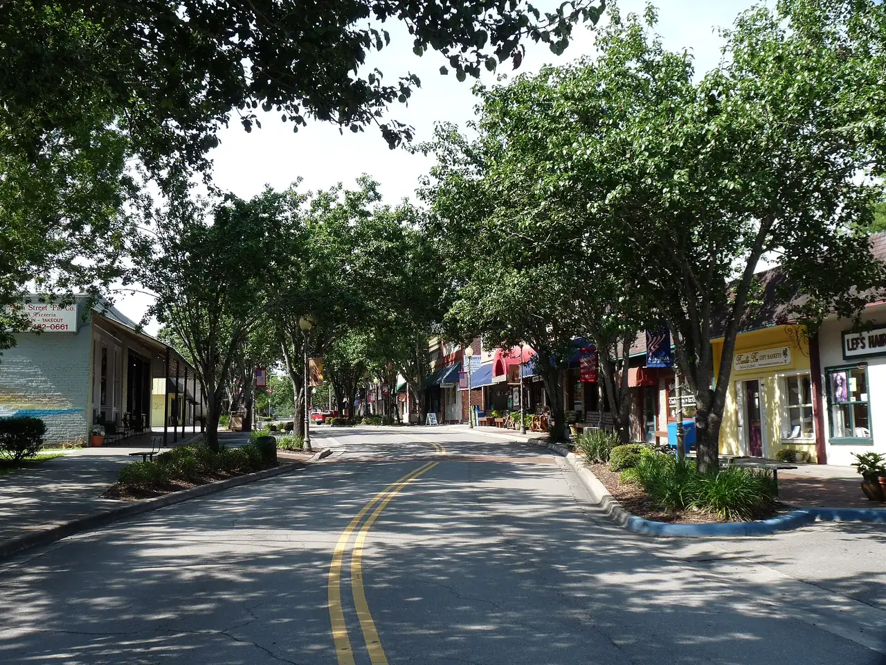 Shops under the shade trees on historic Main Street in Alachua, where the Market on Main sets up on Saturdays.