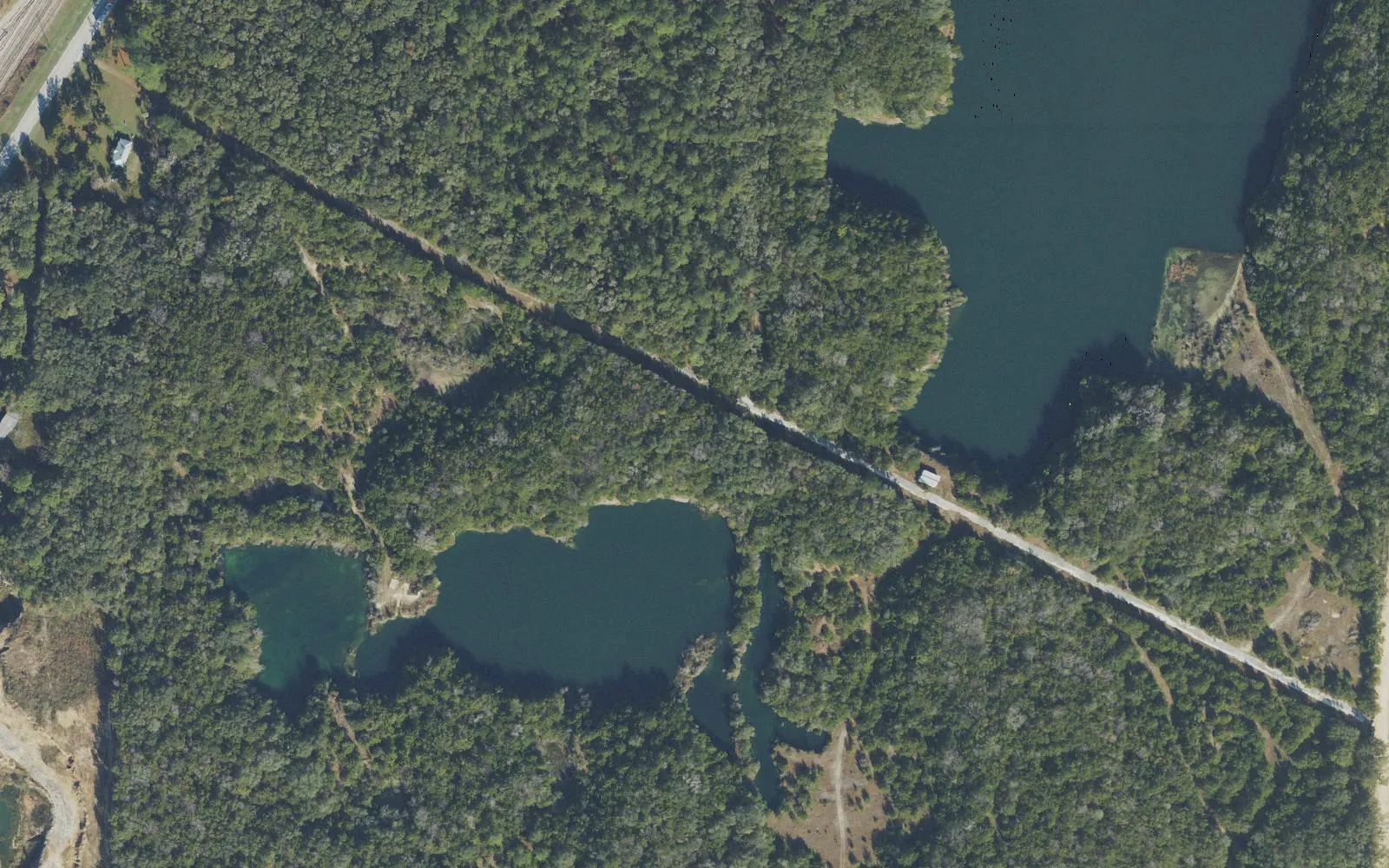 Flooded quarry pits in the woods at Zip! at Haile Quarry, off County Road 235 near Newberry, seen from the air.