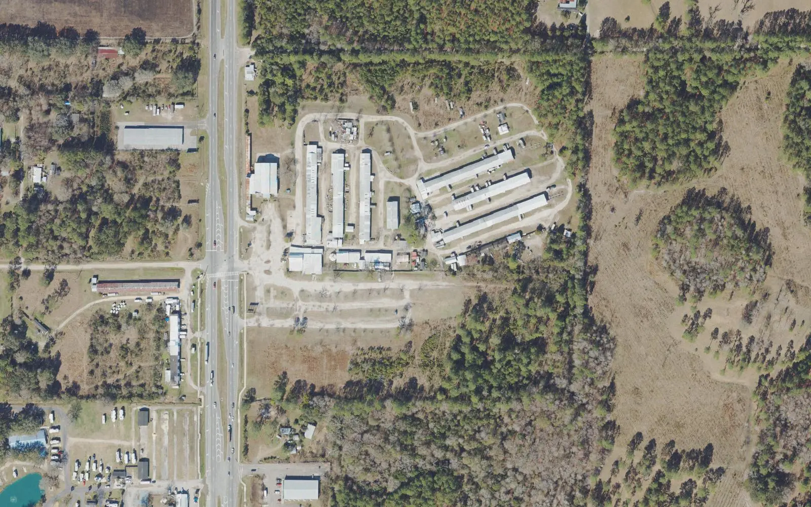 The Waldo Farmers and Flea Market's long vendor sheds beside U.S. 301 in Waldo, seen from the air.
