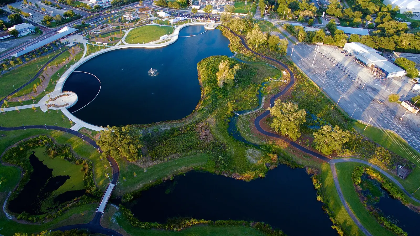Depot Park in downtown Gainesville from the air, with its ponds, lawn and paved trails beside Southeast Depot Avenue.