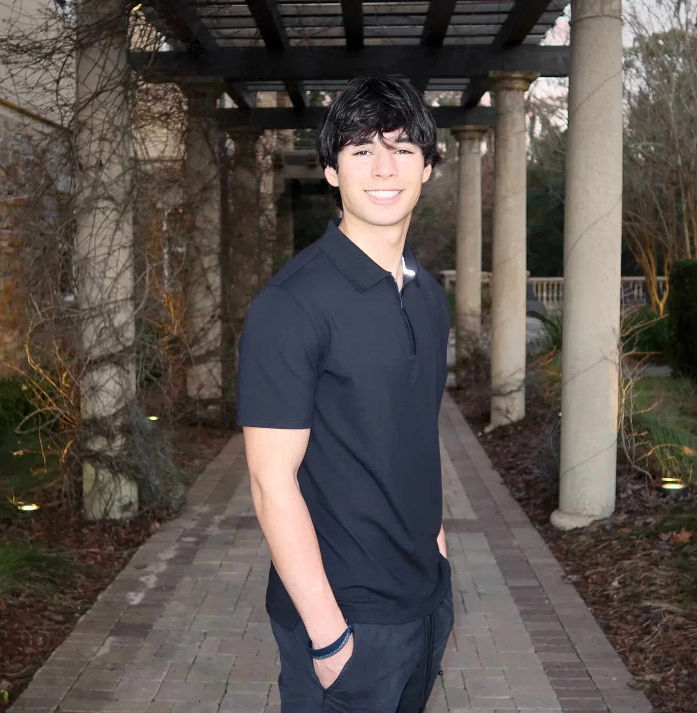 JP Dishinger, founder of Startup Gainesville, standing on a brick path under a pergola