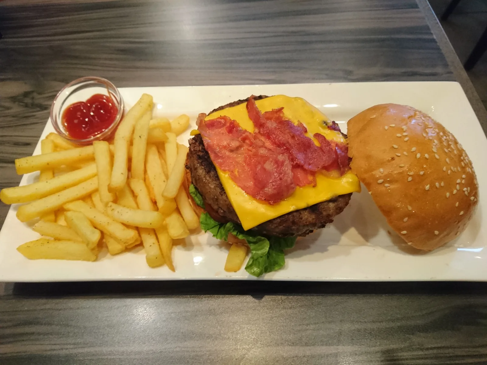 A bacon cheeseburger with fries. The photo was not taken at a Gainesville restaurant.